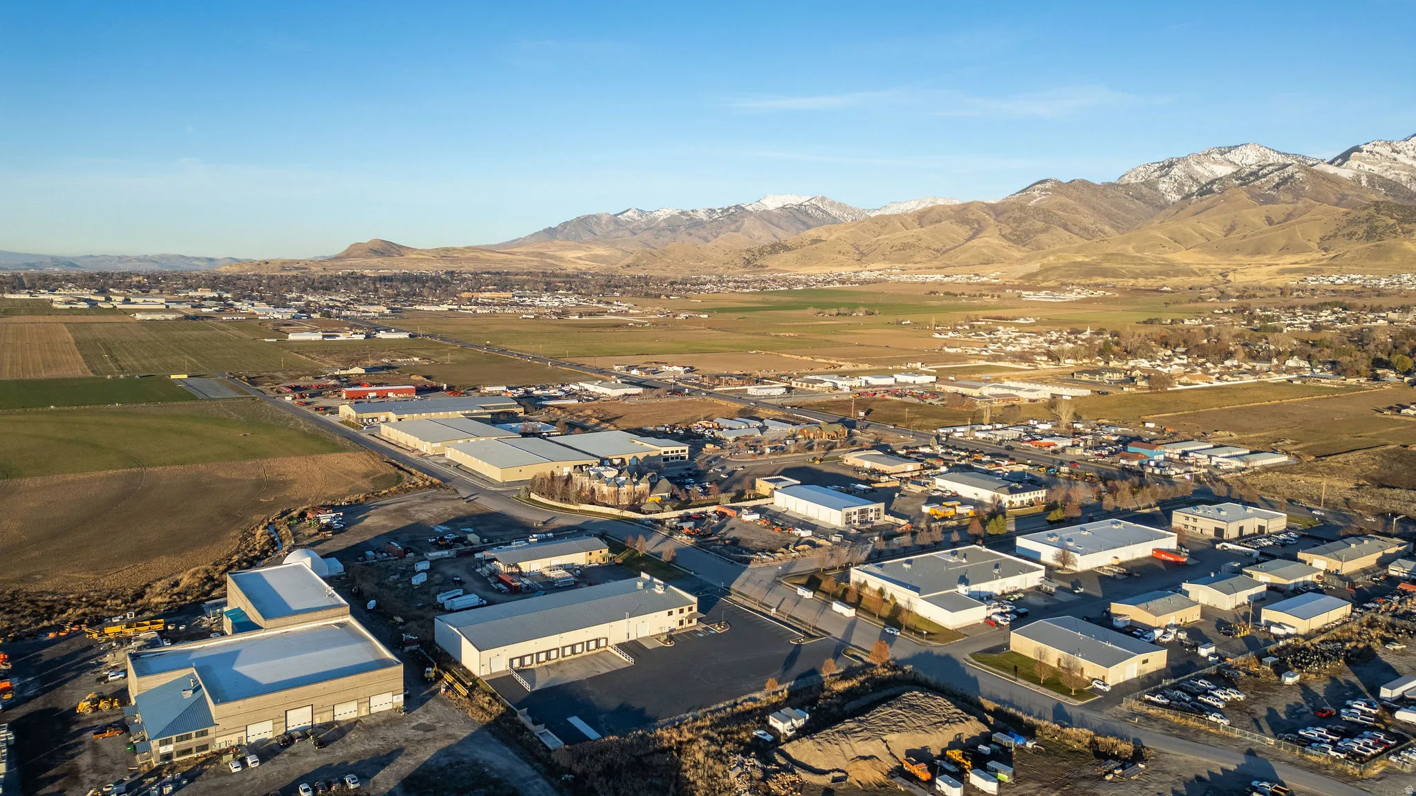 Aerial view of property's location featuring industrial structures and mountains