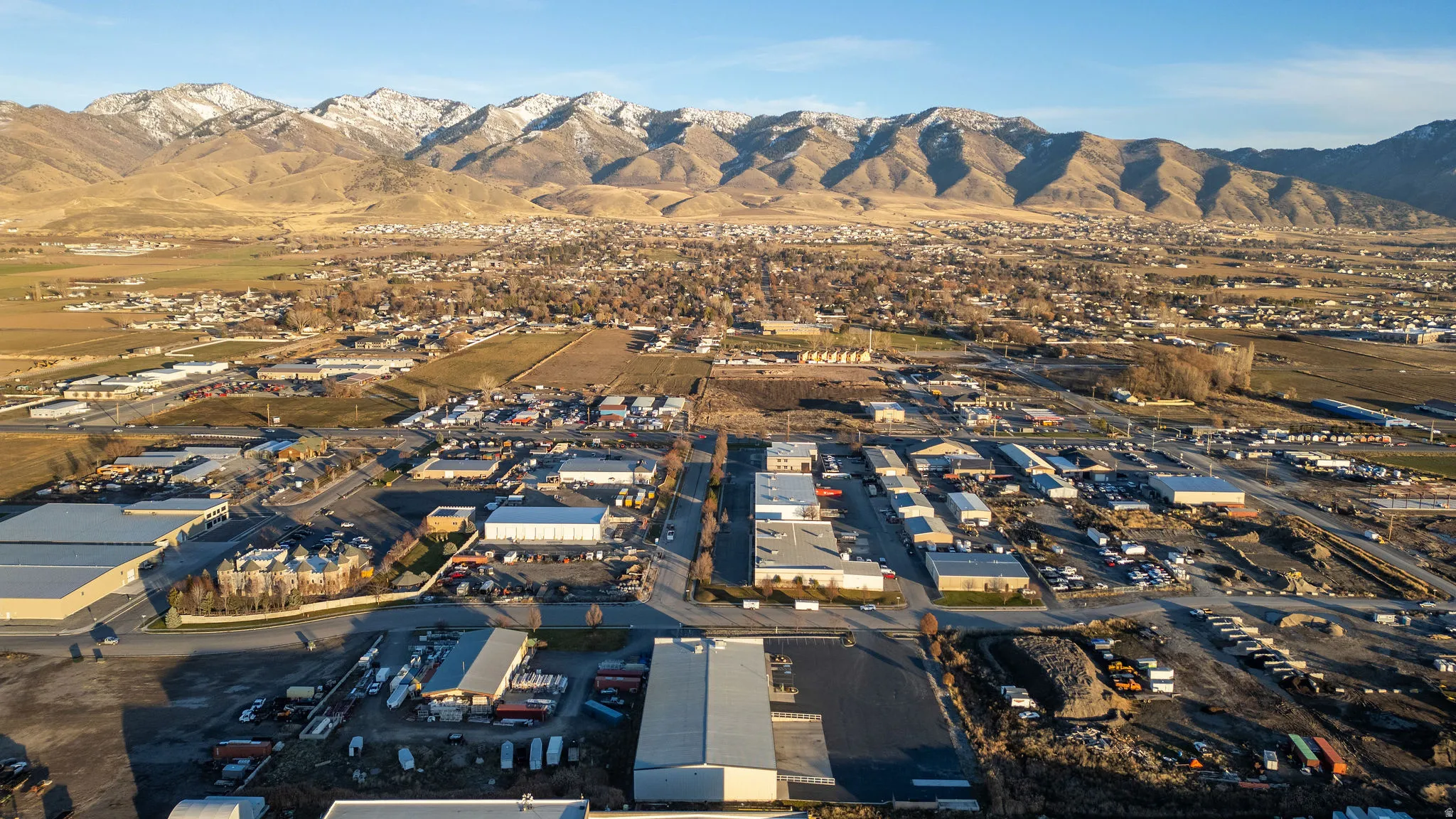 Aerial overview of property's location featuring industrial structures and mountains
