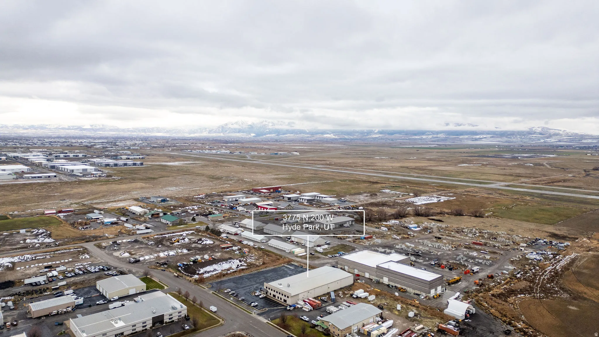 Aerial view of property and surrounding area with an industrial area