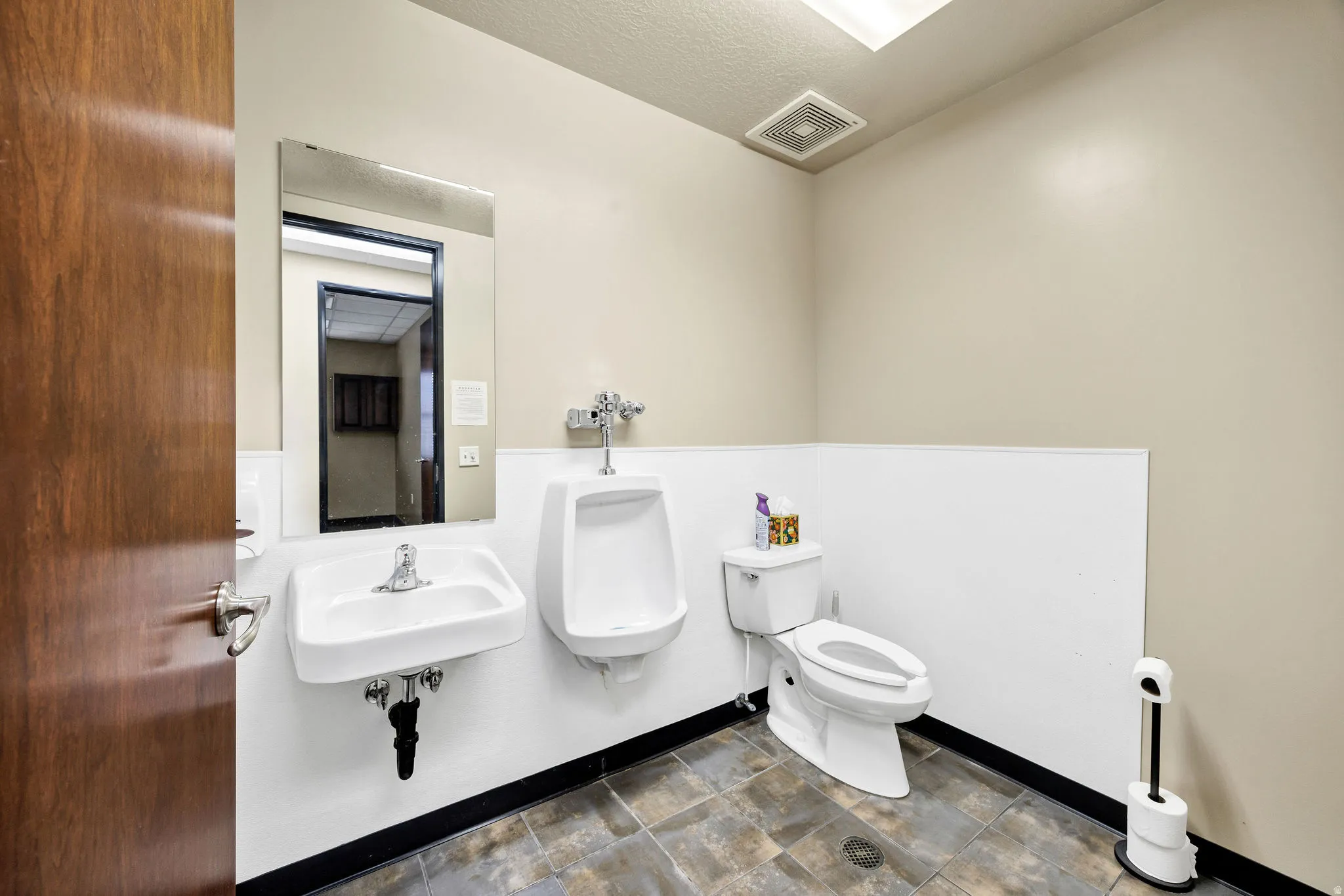 Bathroom featuring toilet and a textured ceiling