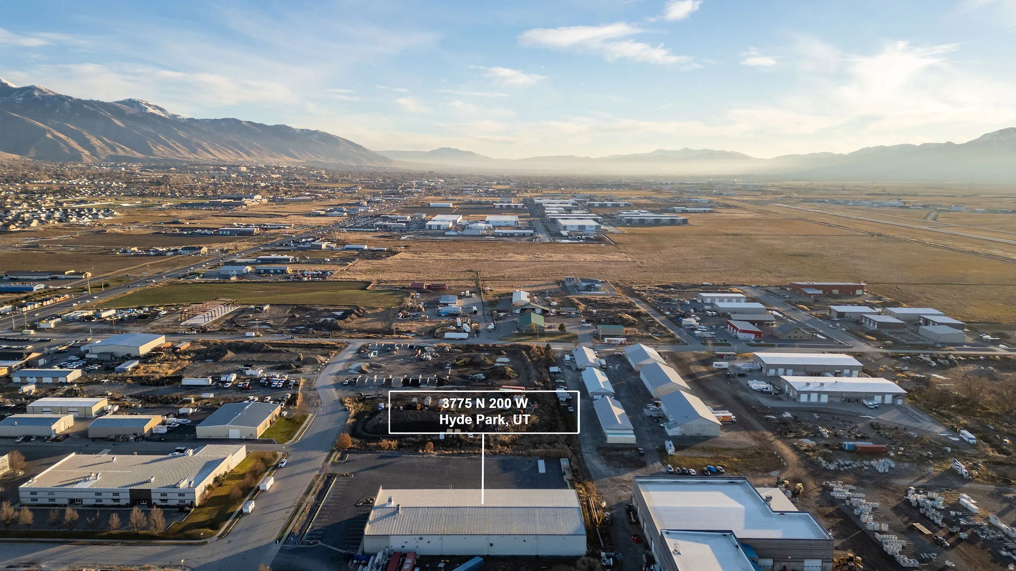 Aerial view of industrial structures and a mountain backdrop