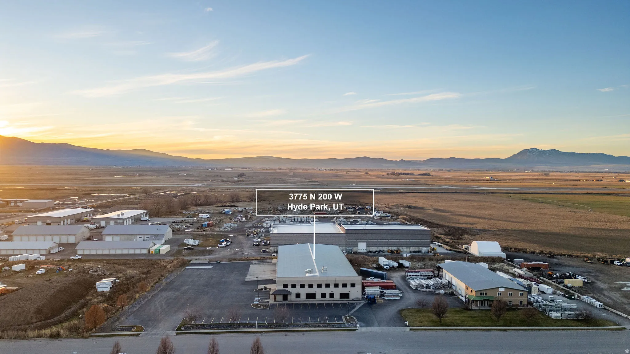 Aerial view of industrial structures and a mountainous background