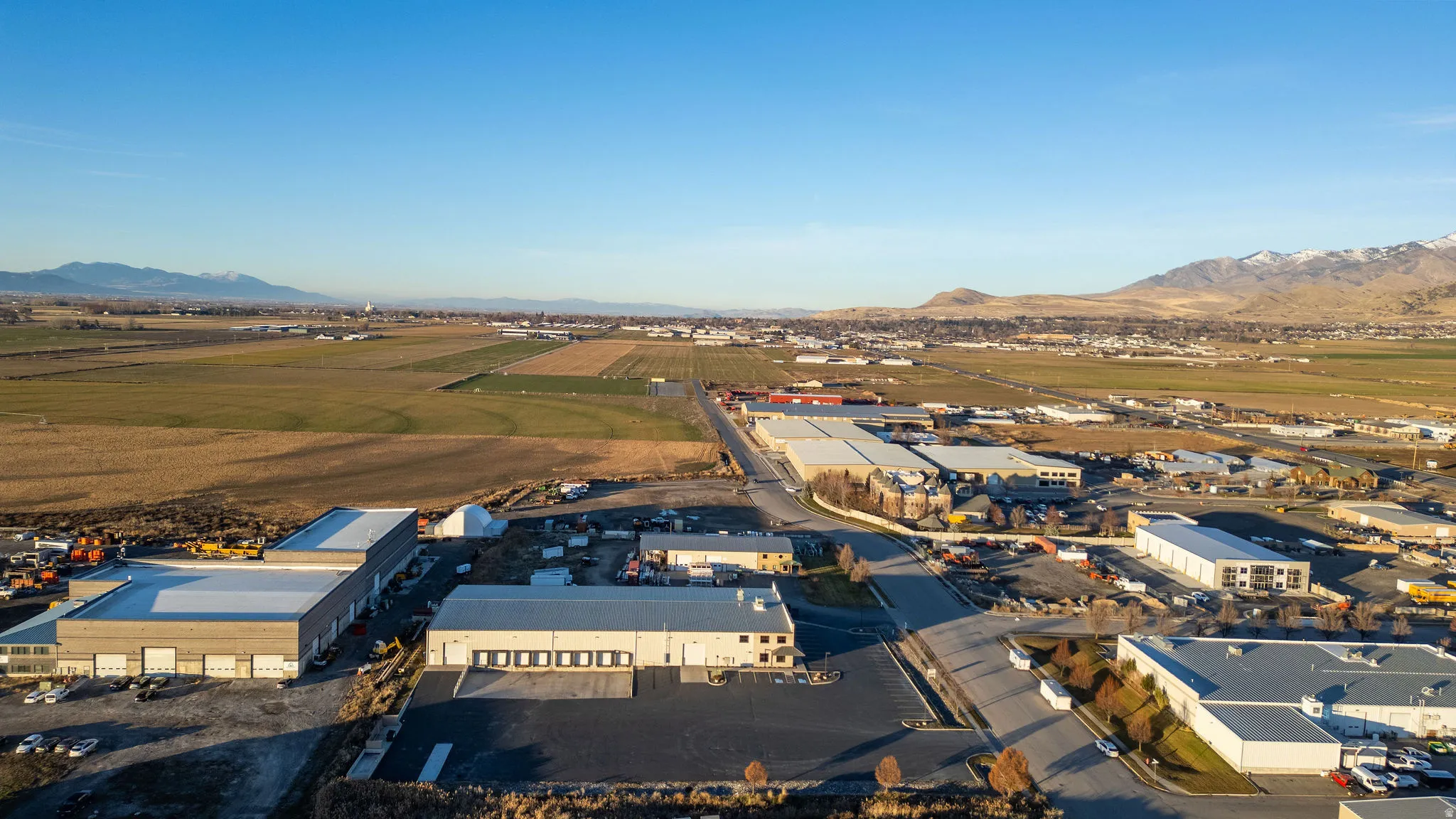 Aerial view of industrial structures and a mountain backdrop