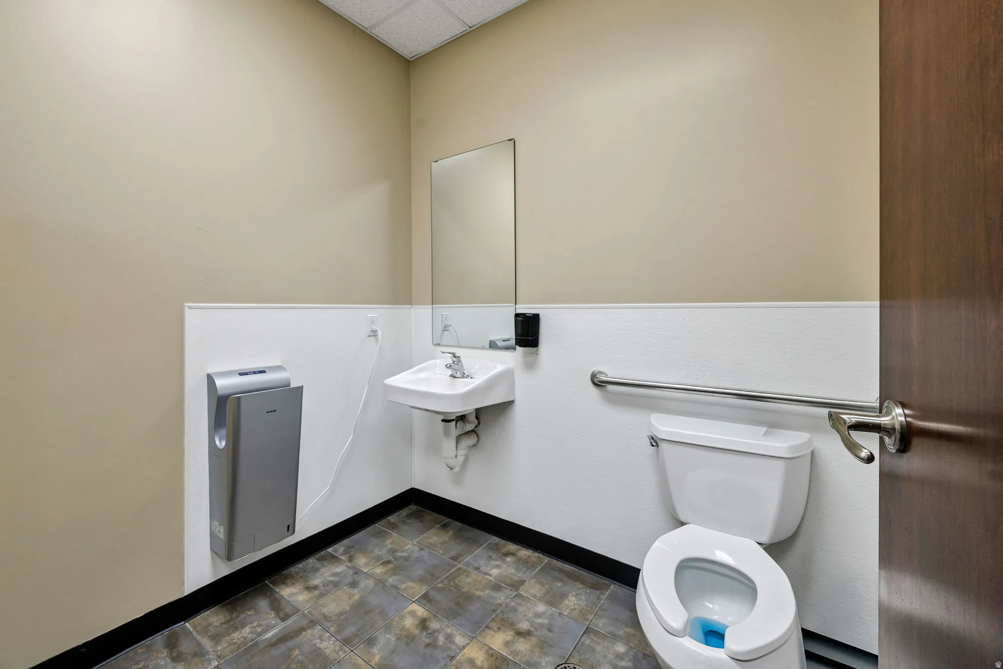 Half bath featuring a drop ceiling and toilet