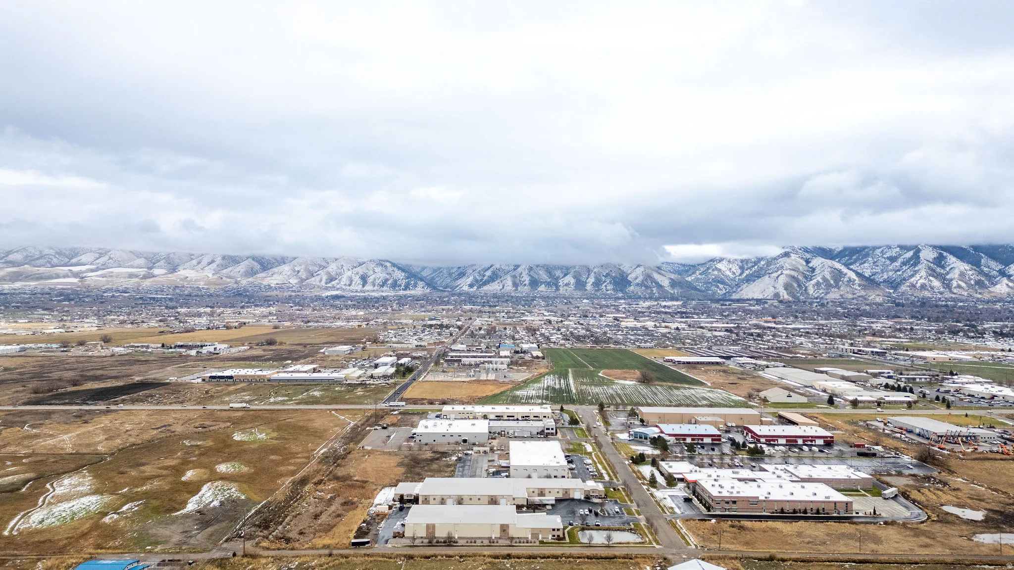 Bird's eye view of an industrial area and a mountain backdrop