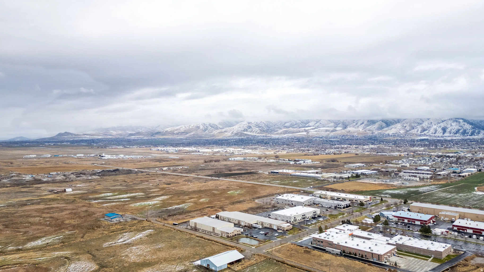 Drone / aerial view of a mountainous background and an industrial area