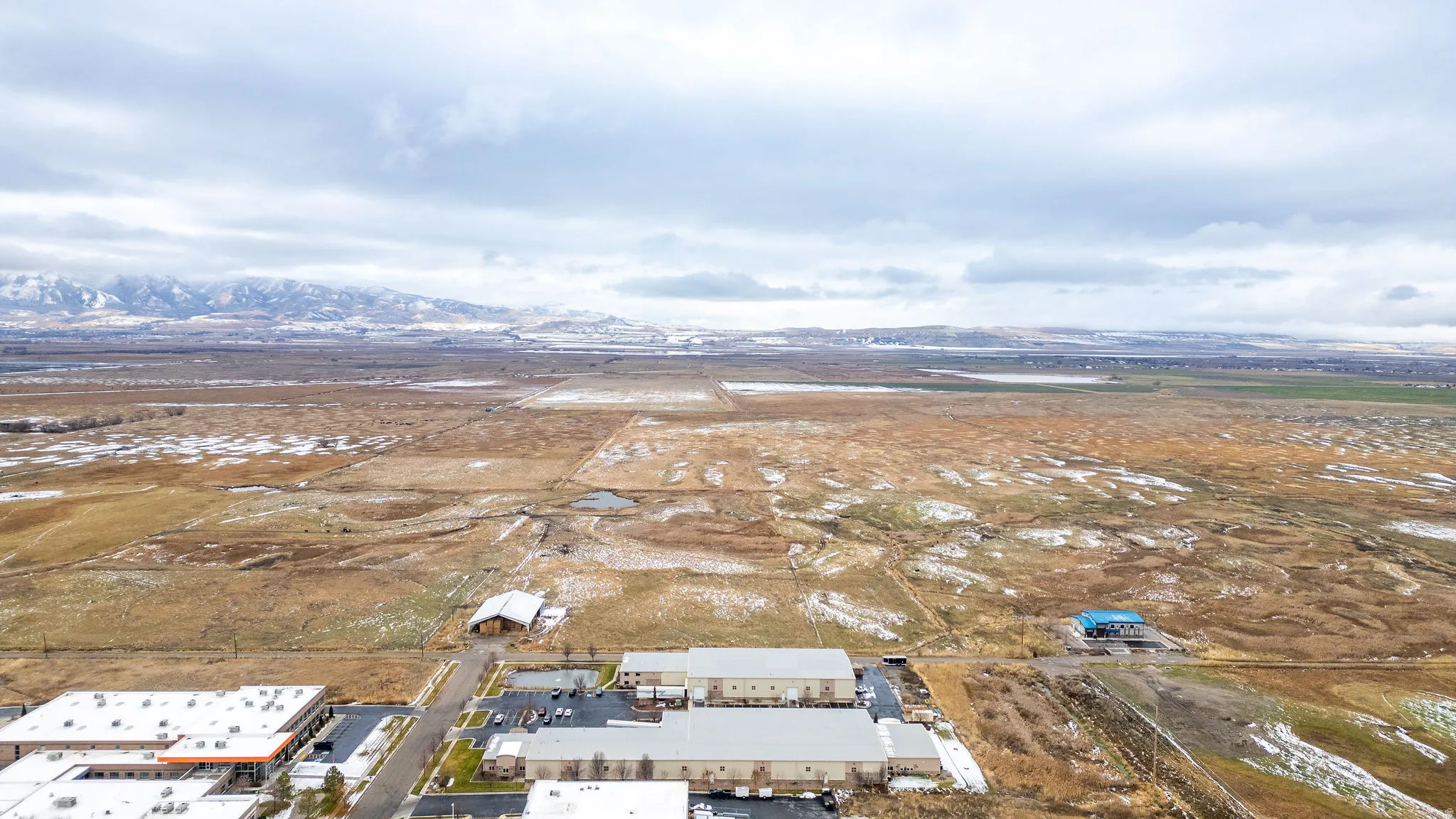 Aerial view of property's location with a mountainous background and rural landscape