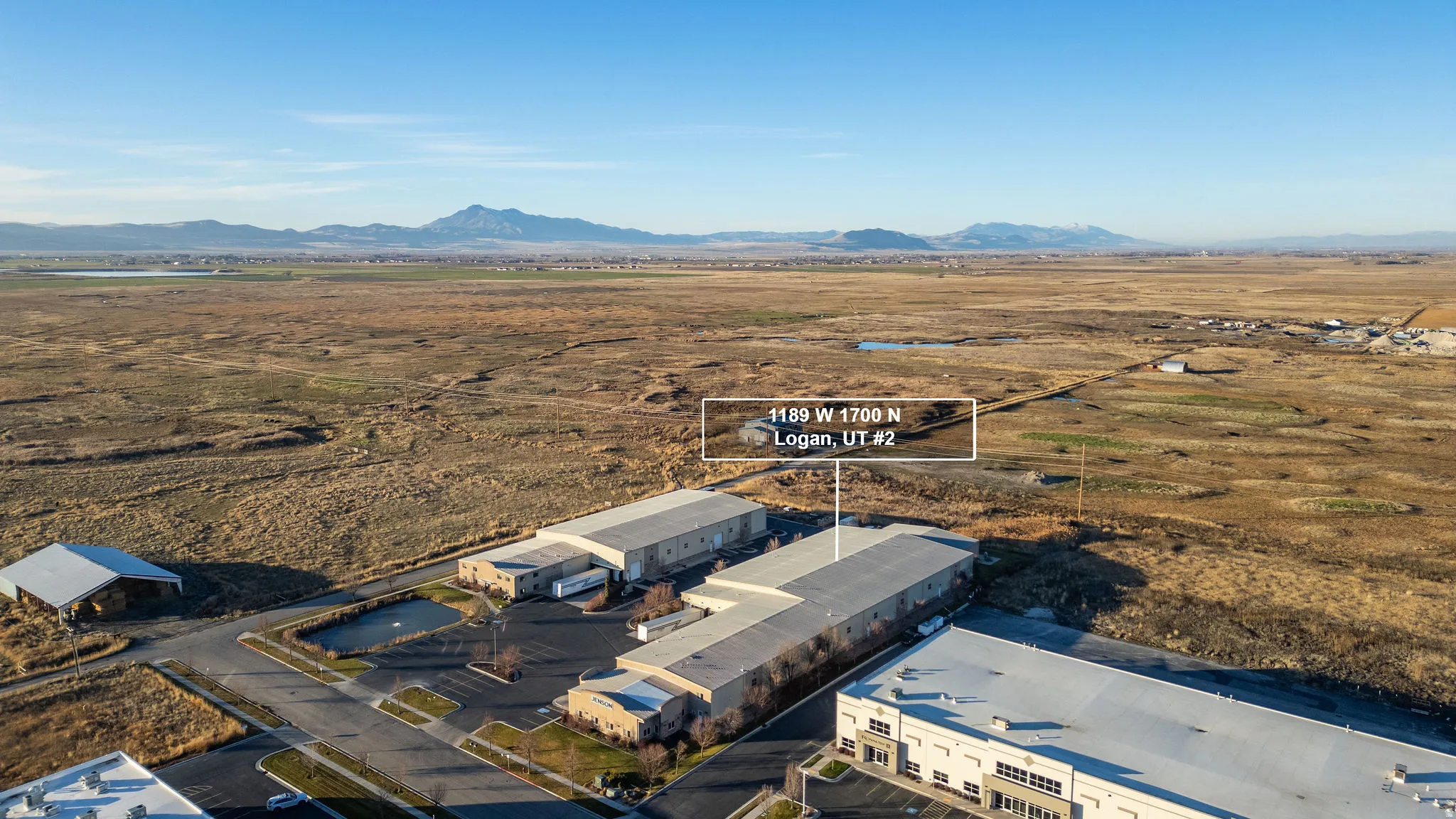 Aerial view of sparsely populated area with a mountain backdrop and a desert landscape