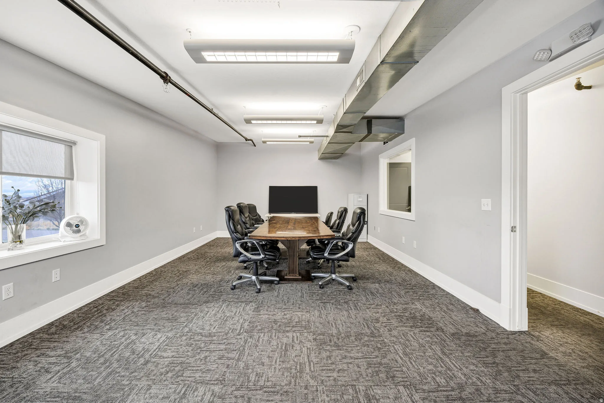 Office space with dark carpet and baseboards