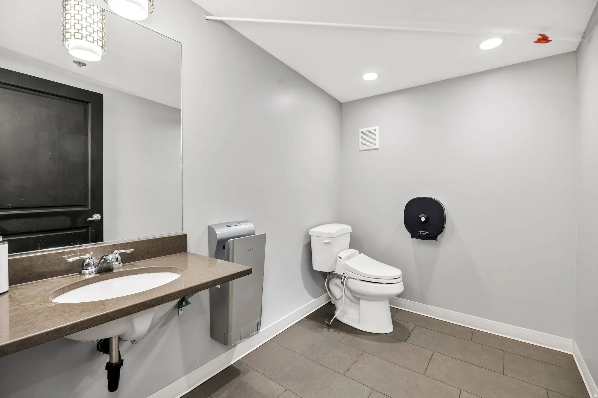 Bathroom featuring tile patterned floors and recessed lighting