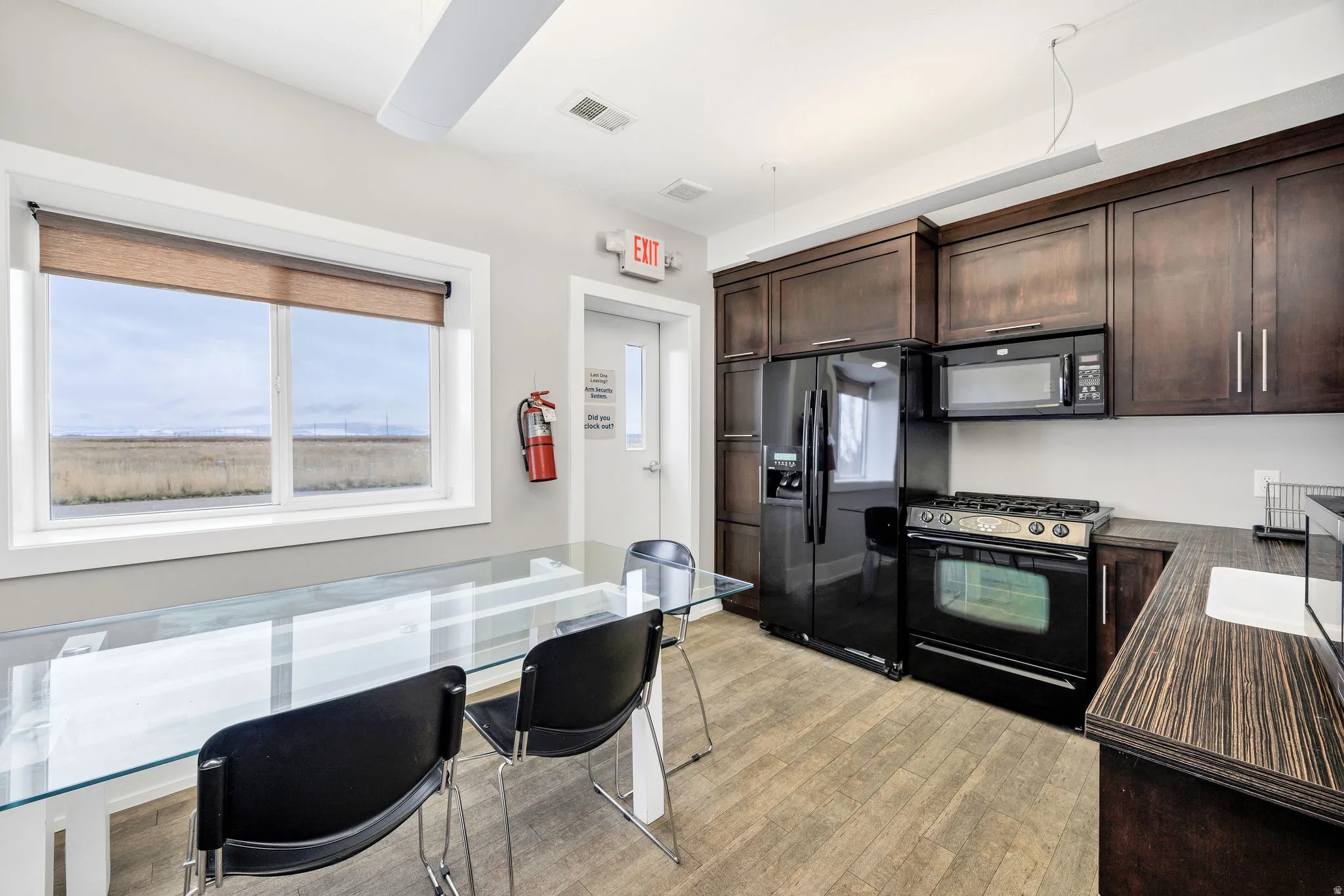 Kitchen with dark brown cabinetry and black appliances