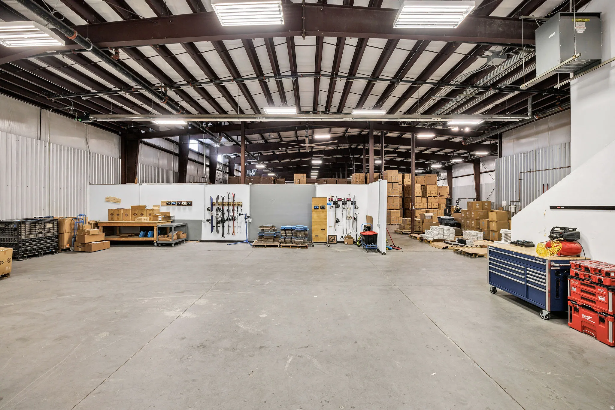 Garage featuring a workshop area and metal wall