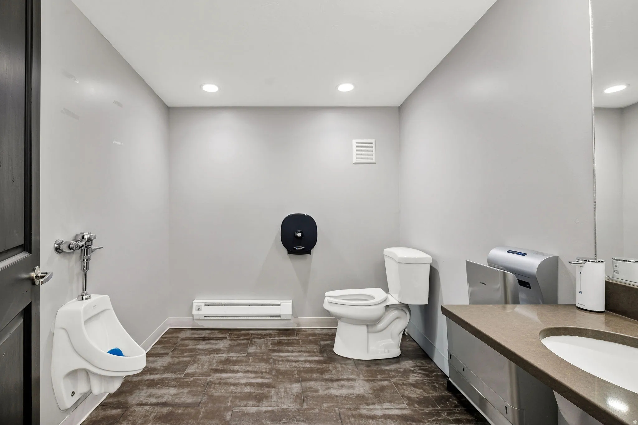 Bathroom with recessed lighting, a baseboard heating unit, and vanity