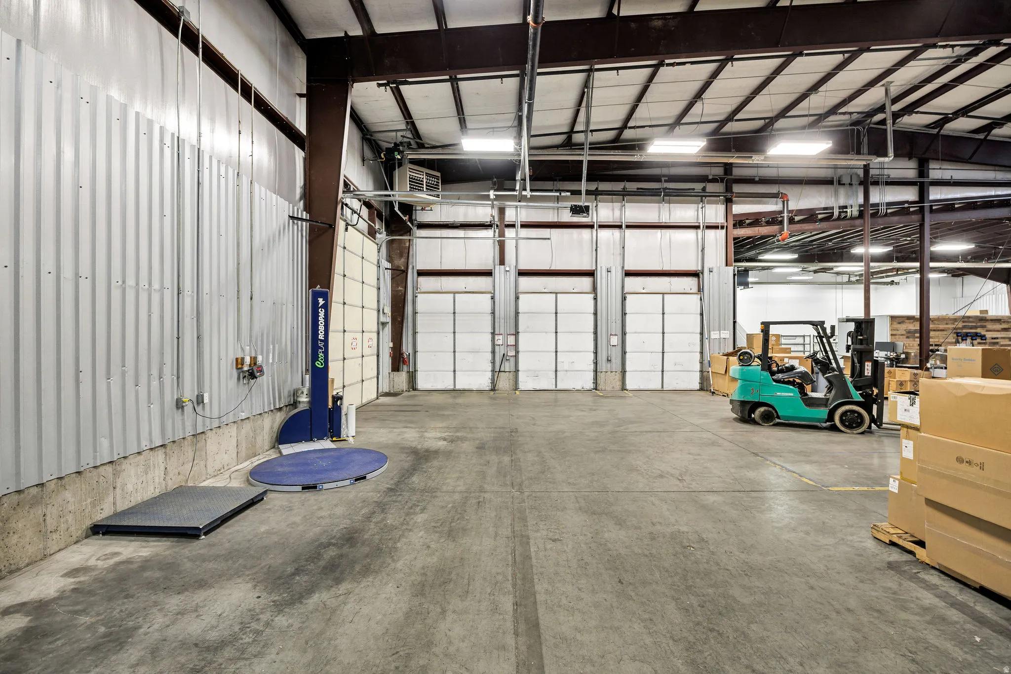 Garage featuring metal wall and a heating unit
