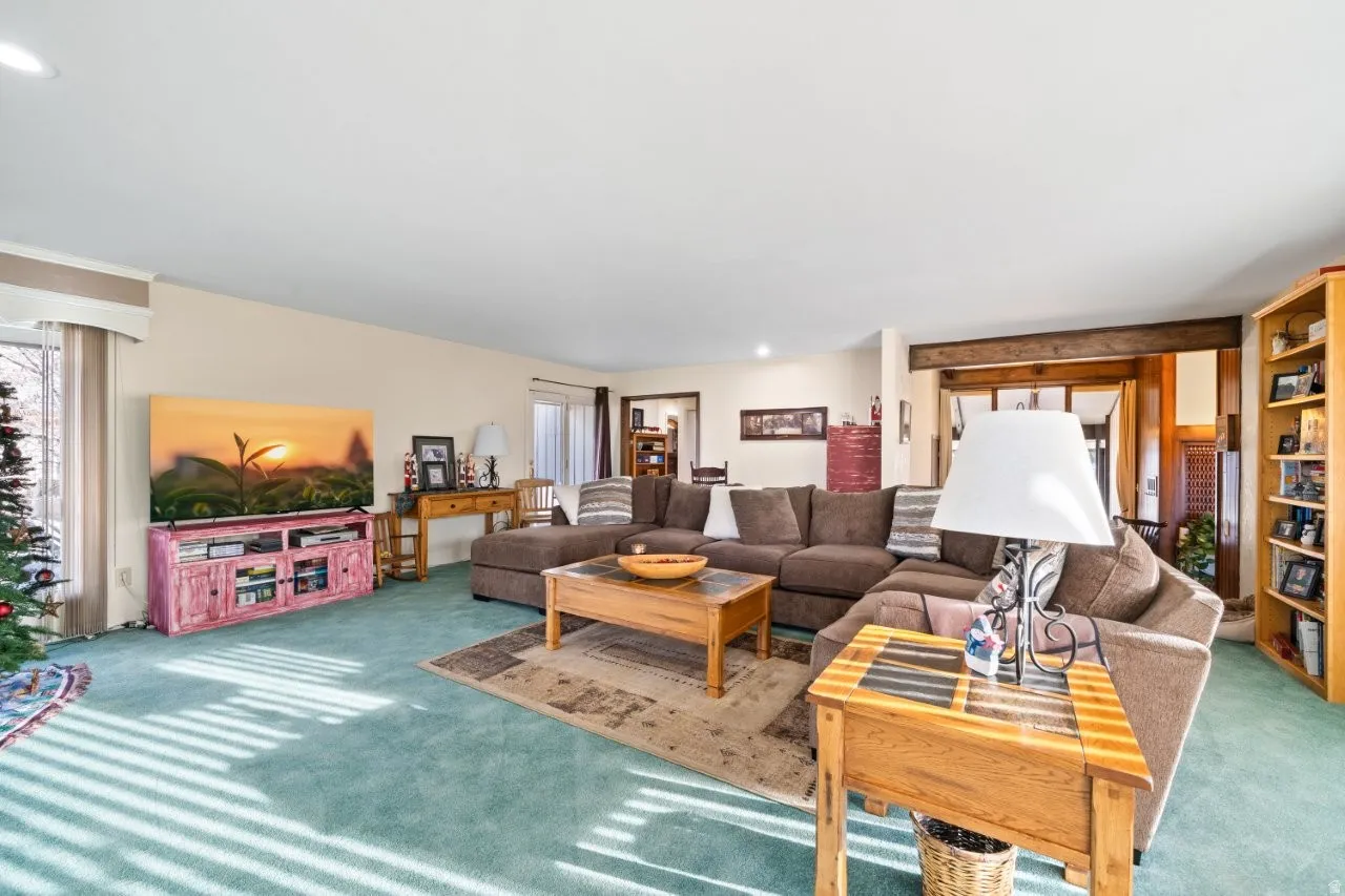 Carpeted living room with recessed lighting