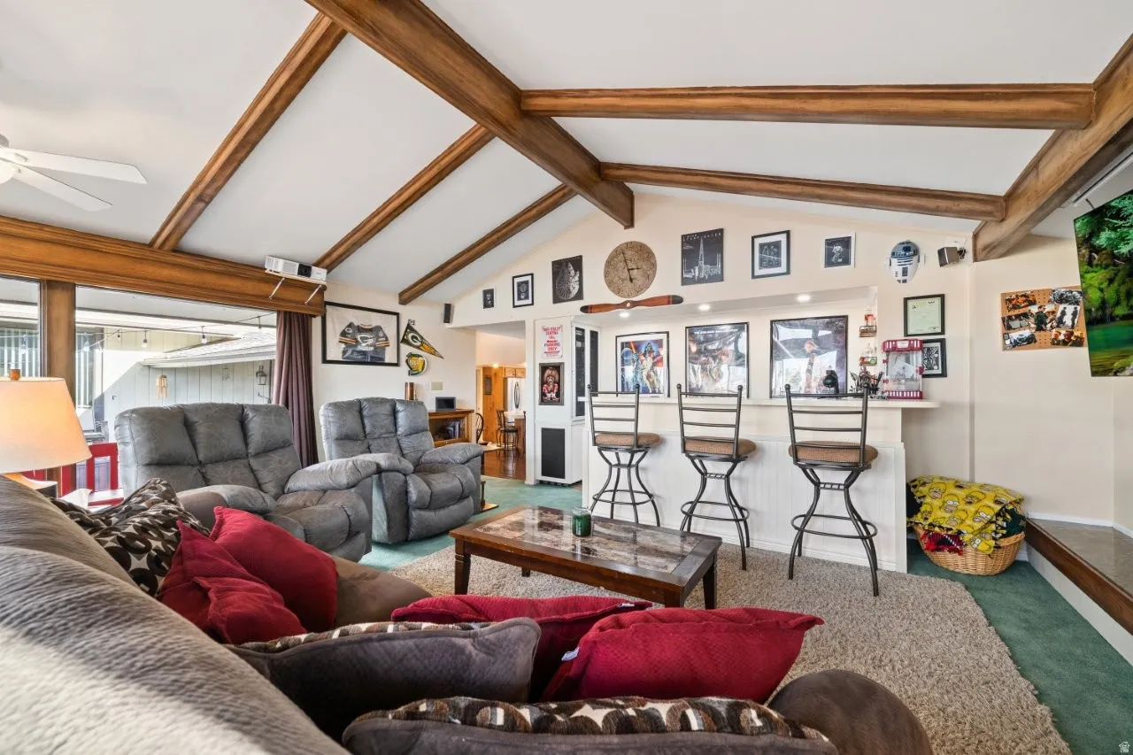 Living area featuring carpet floors and ceiling fan