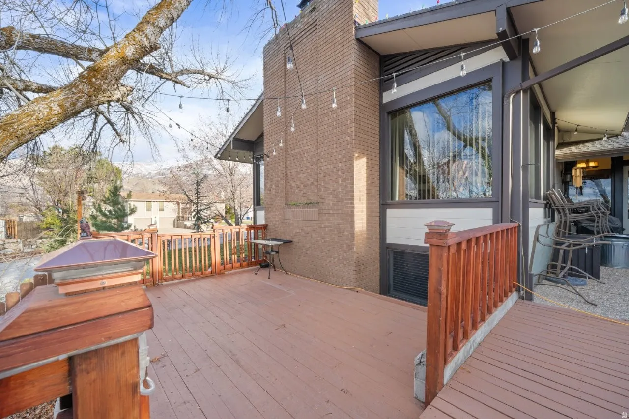 Wooden deck featuring area for grilling