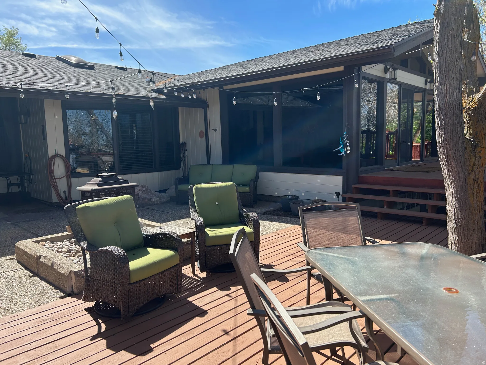 Wooden deck featuring outdoor lounge area, a sunroom, and a patio
