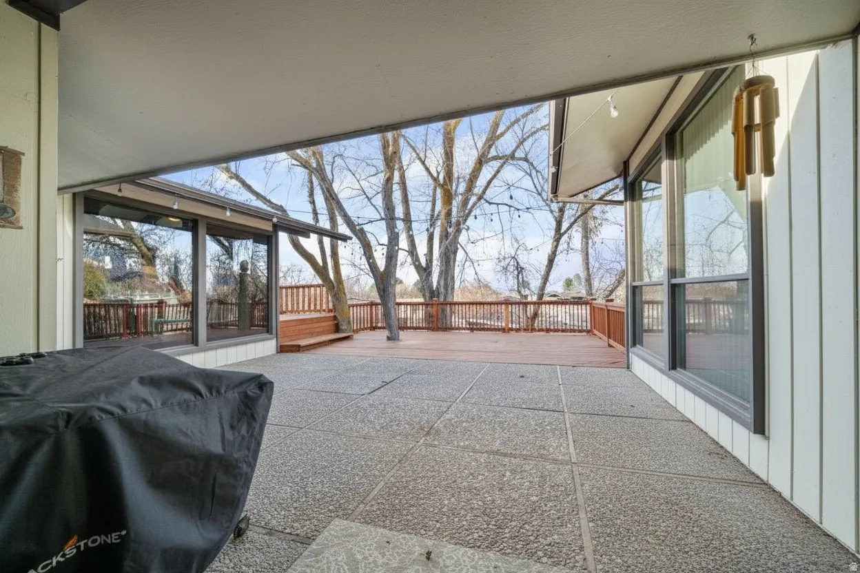 Spacious concrete patio with an overhead cover