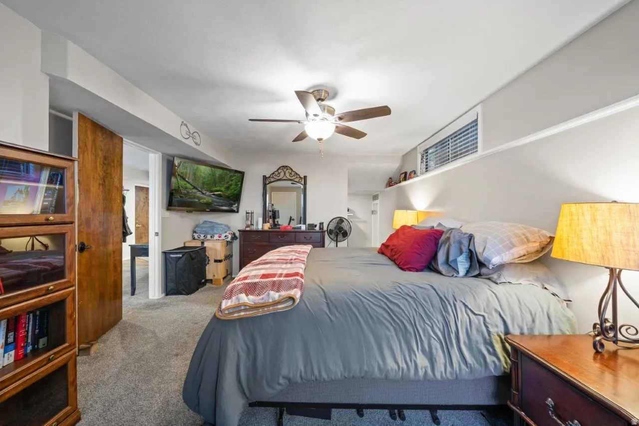 Carpeted bedroom with ceiling fan