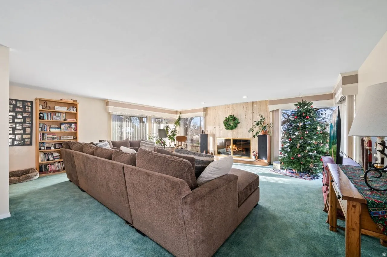 Living area featuring a fireplace and carpet floors