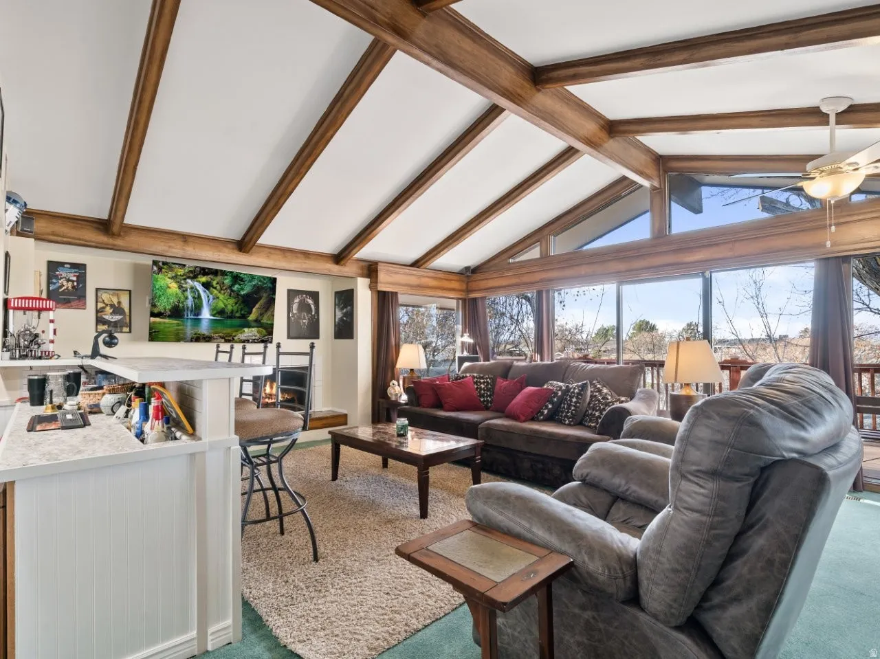 Carpeted living room with ceiling fan