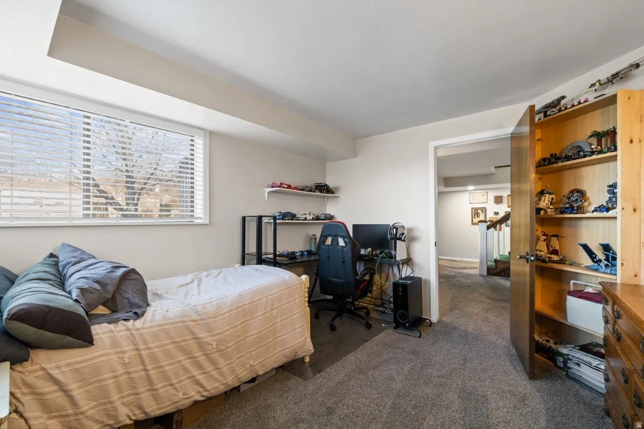 Bedroom featuring carpet floors and a desk