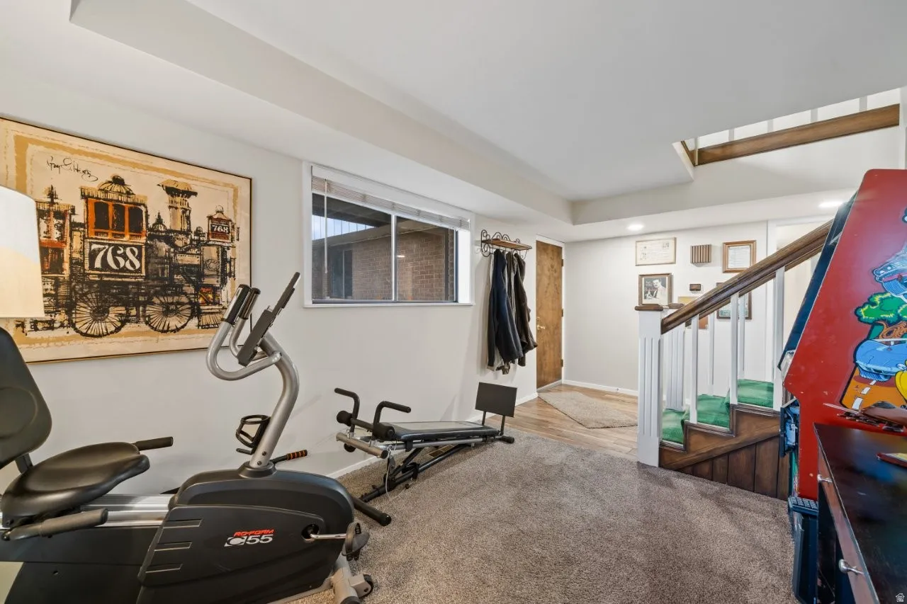 Workout room with light colored carpet