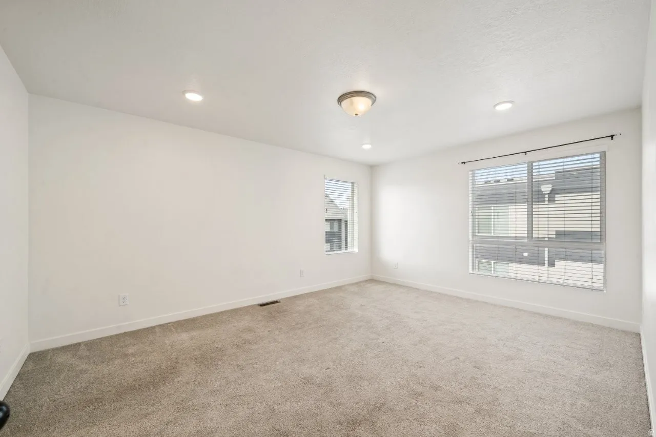 Unfurnished room featuring light carpet and recessed lighting