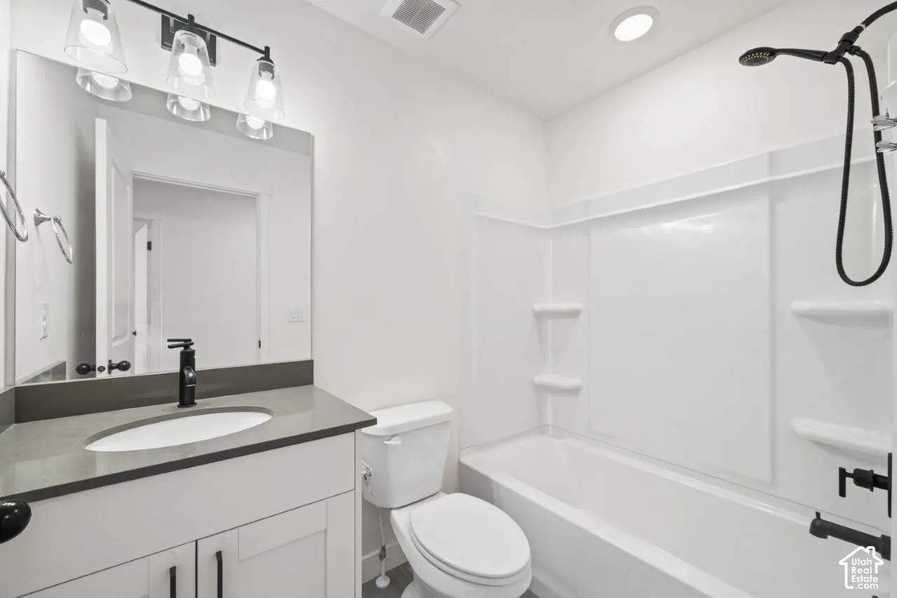 Bathroom with shower / bath combination and vanity