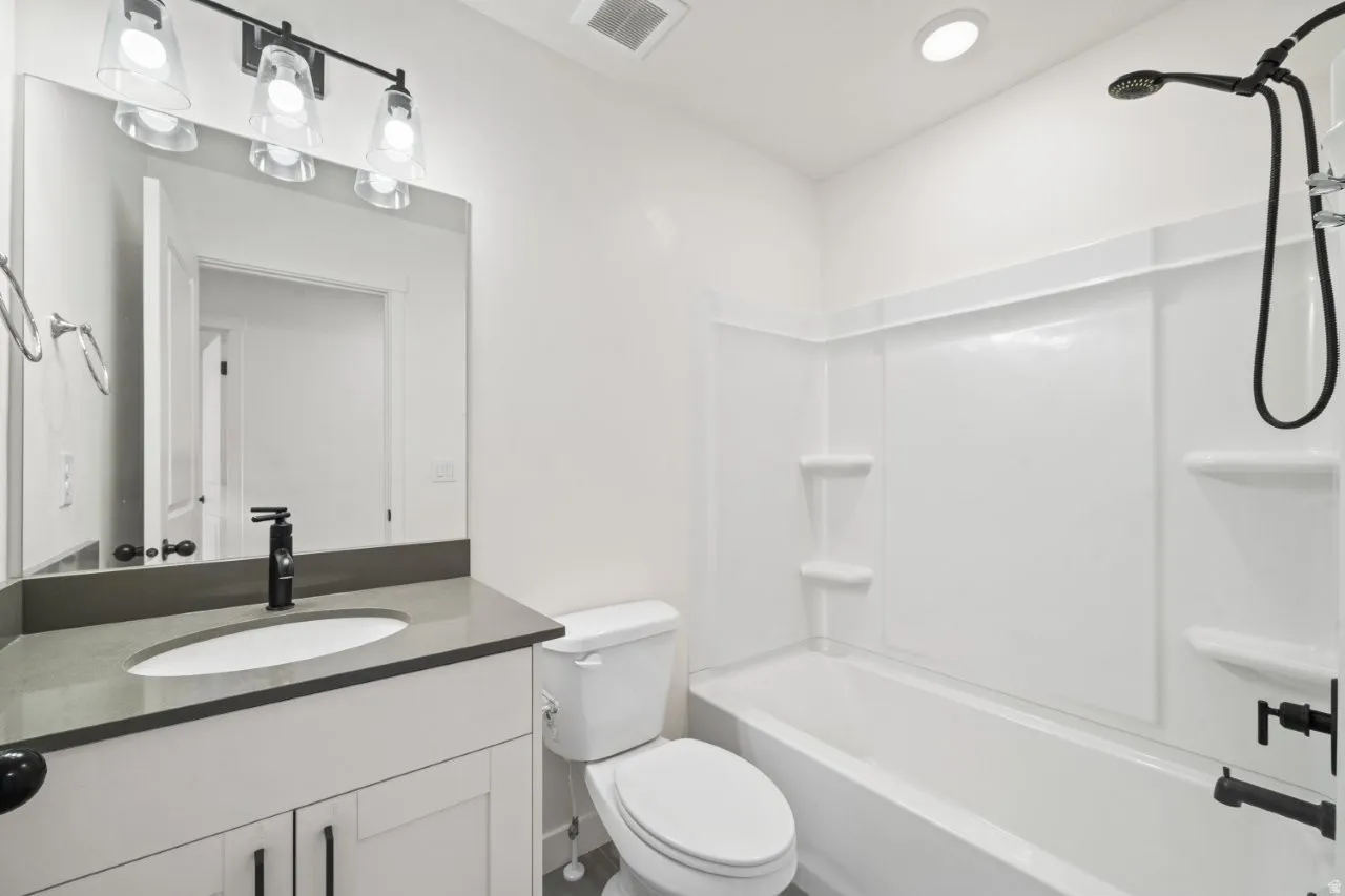 Bathroom with shower / bath combination and vanity