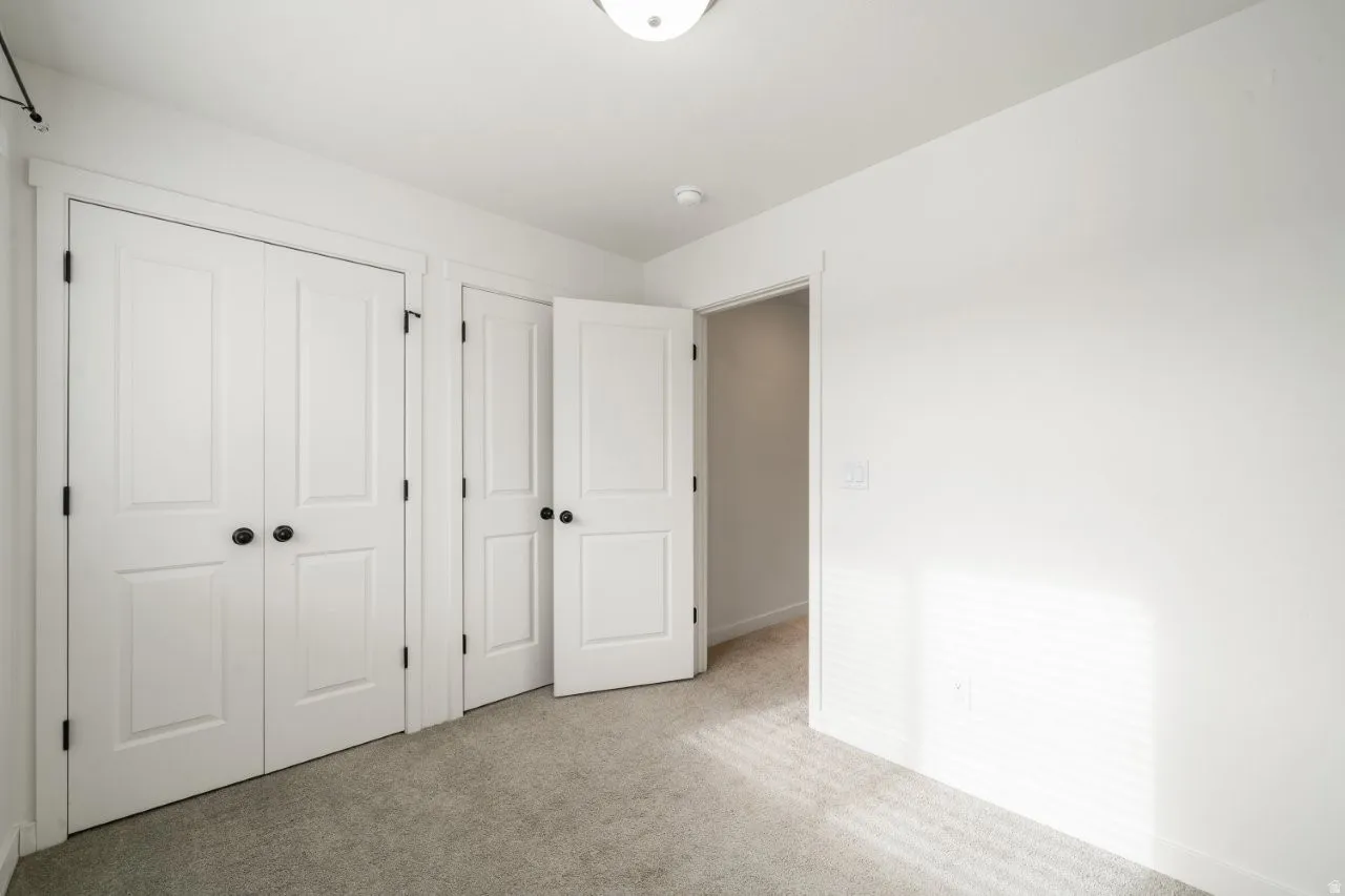 Unfurnished bedroom with carpet floors and a closet