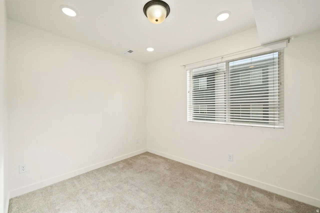 Unfurnished room featuring carpet floors and recessed lighting