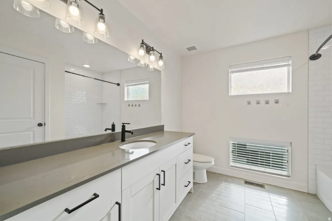Full bathroom featuring vanity, bathing tub / shower combination, and light tile patterned floors