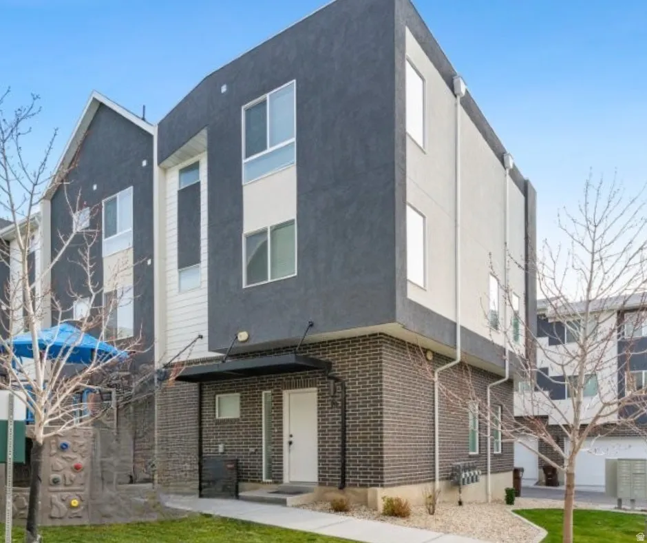 Front of house featuring stucco siding and brick siding