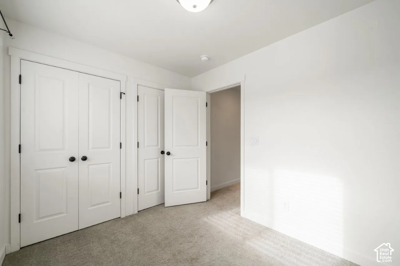 Unfurnished bedroom with carpet floors and a closet