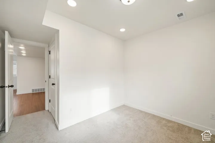 Spare room with carpet and recessed lighting