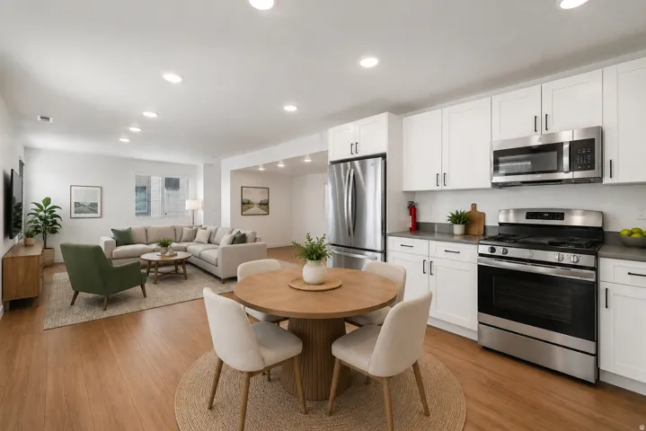 Spacious open-concept living area featuring wood-finish flooring and recessed lighting