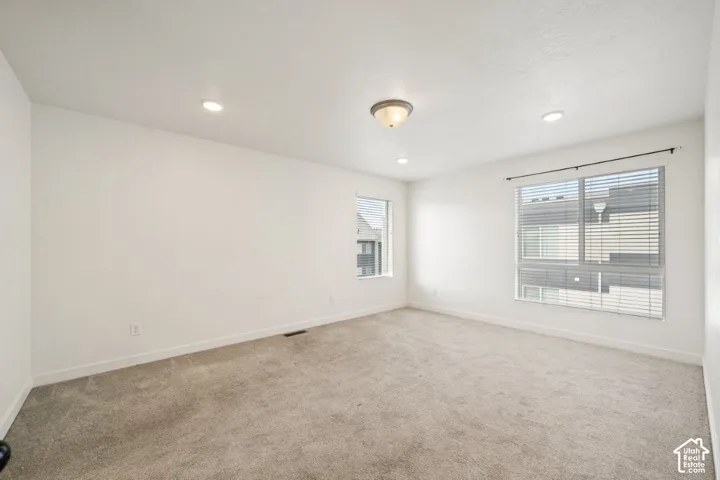 Unfurnished room featuring light carpet and recessed lighting