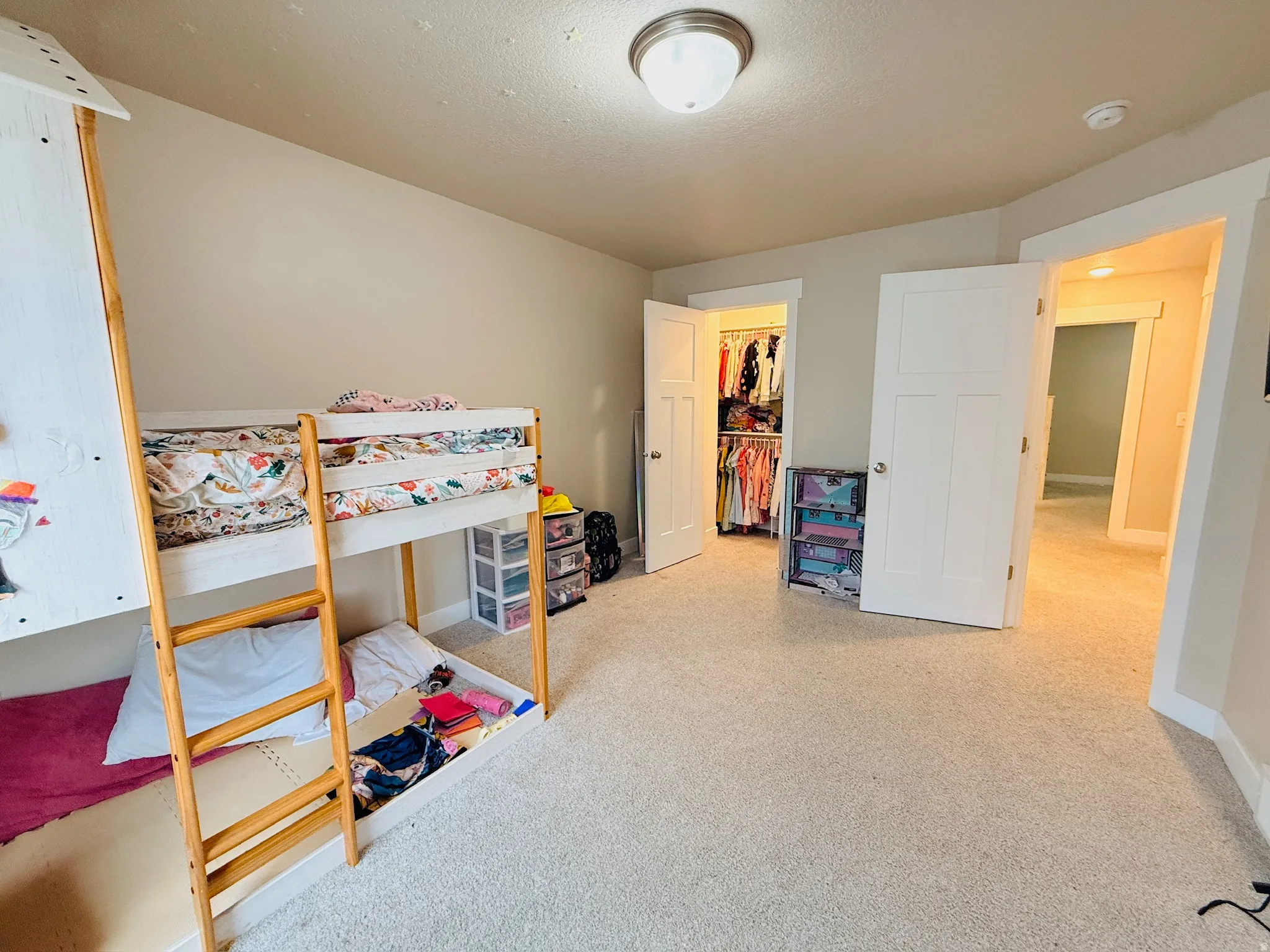 Bedroom featuring a spacious closet and a textured ceiling
