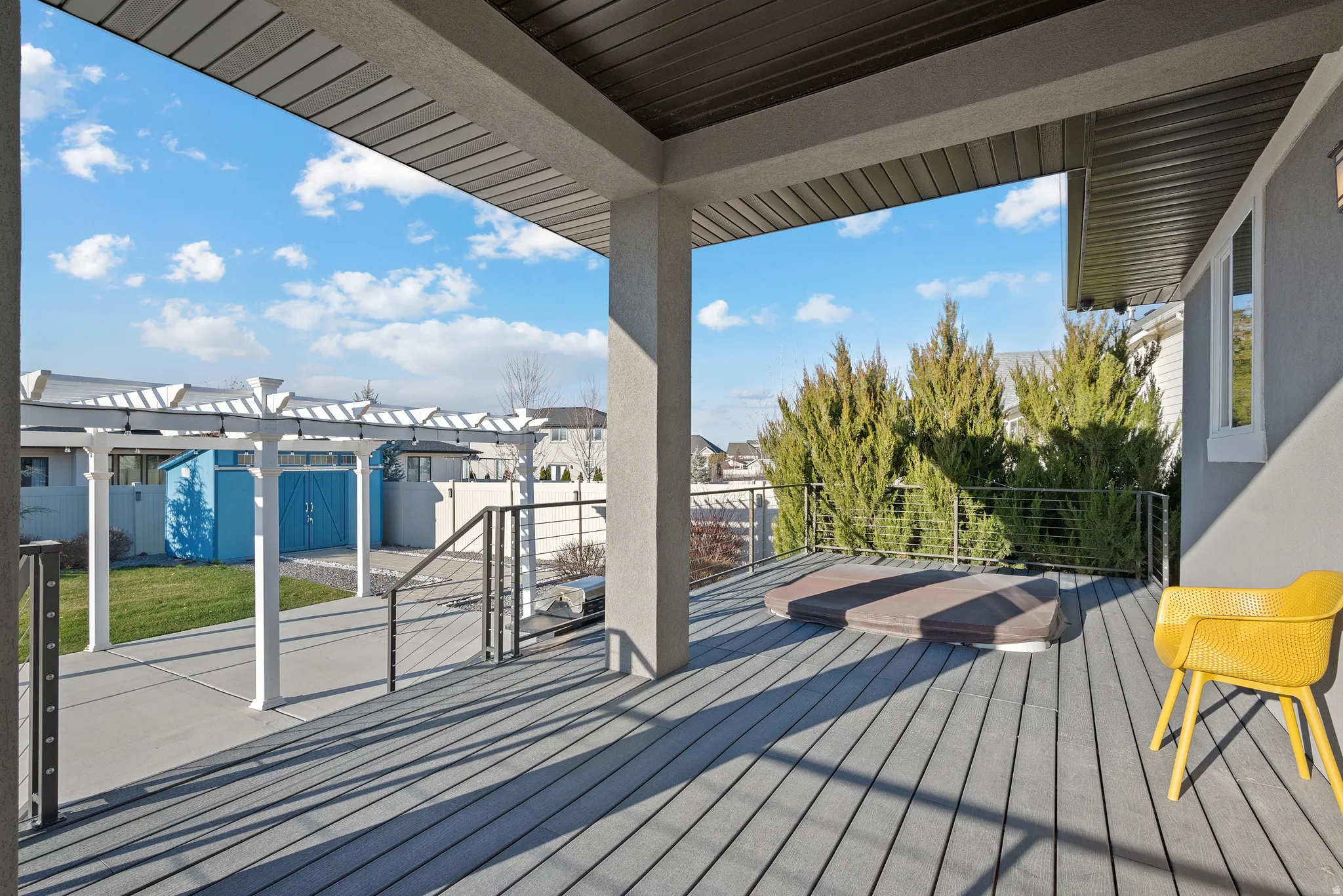 Wooden deck with a pergola, a residential view, and a patio area
