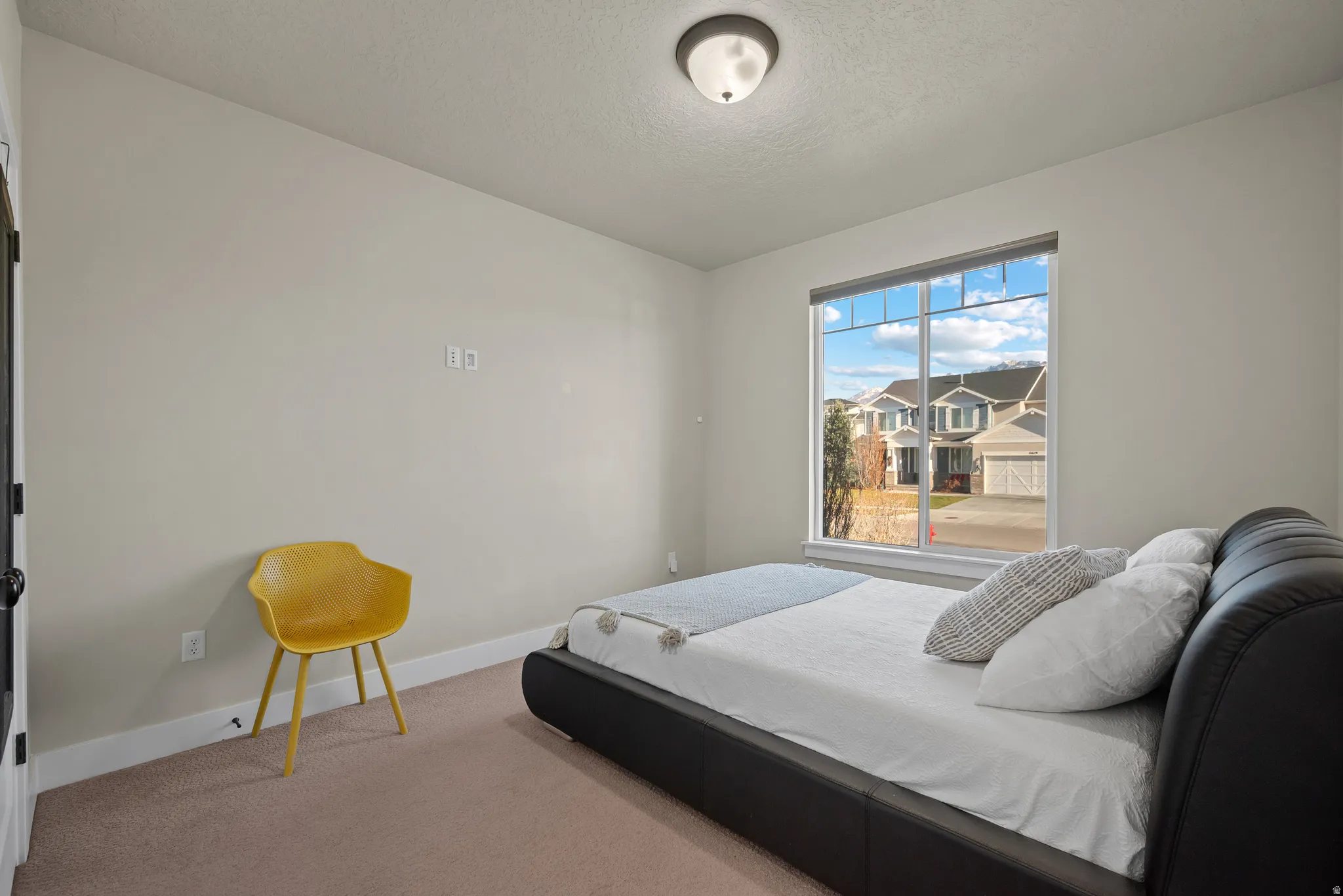 Bedroom with carpet floors and a textured ceiling