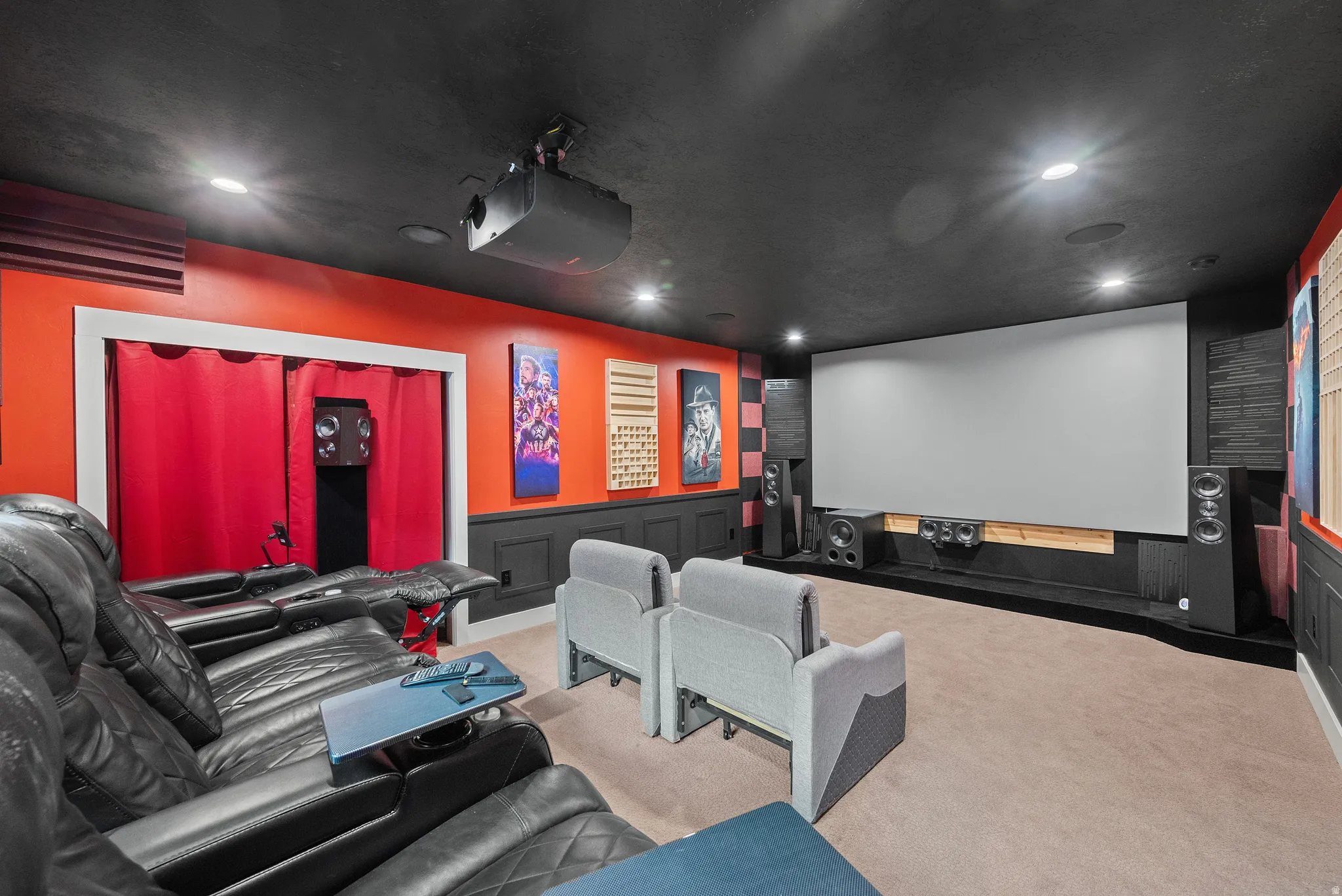 Carpeted home theater room with a wainscoted wall, a decorative wall, and recessed lighting