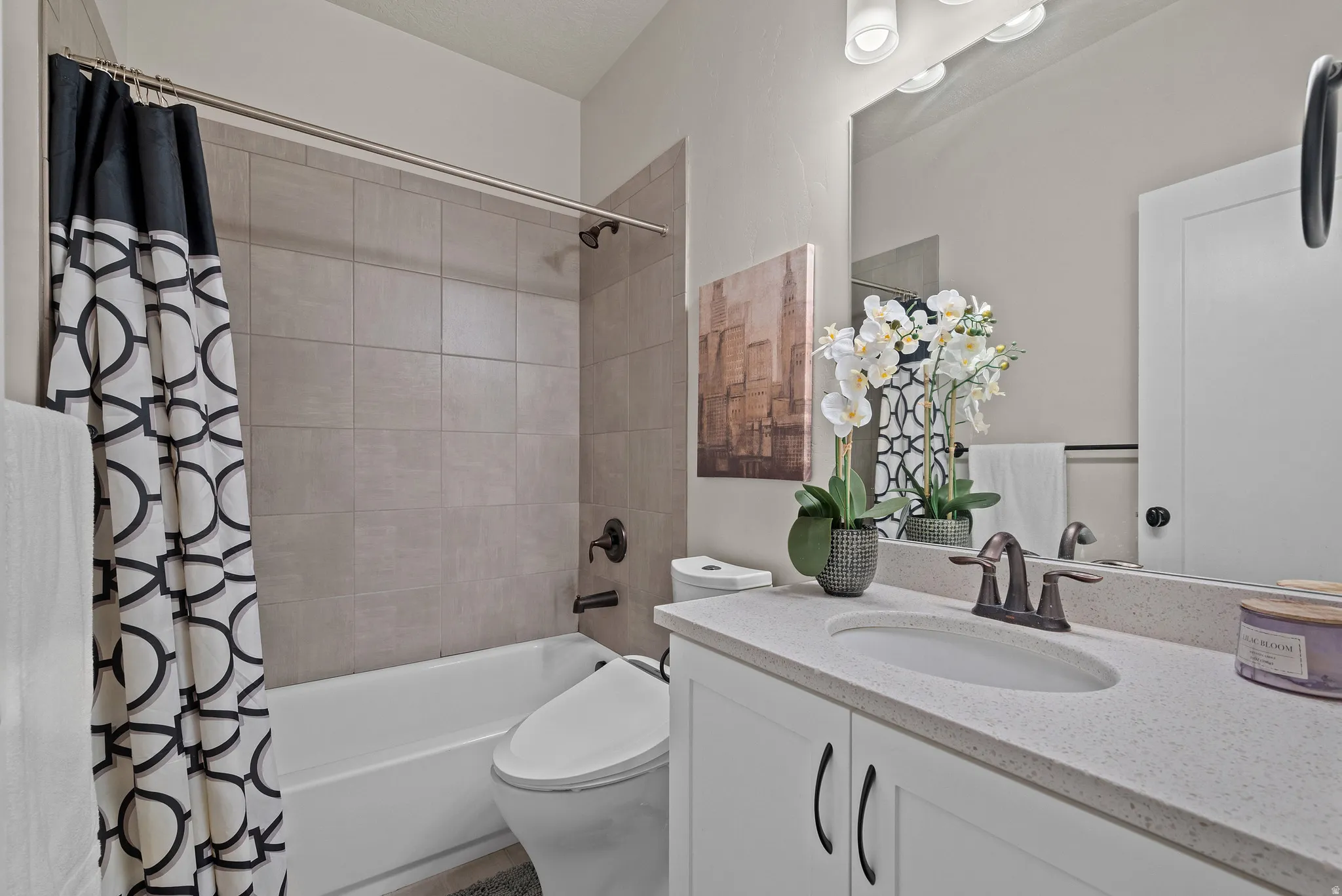 Bathroom with shower / bath combo and vanity