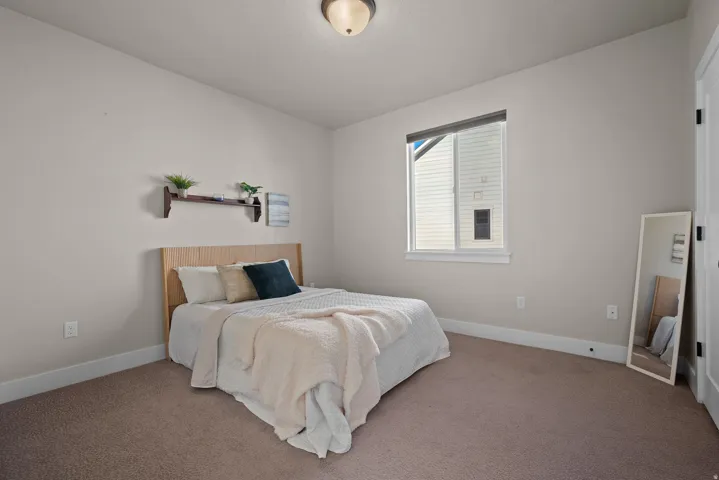 Carpeted bedroom featuring baseboards