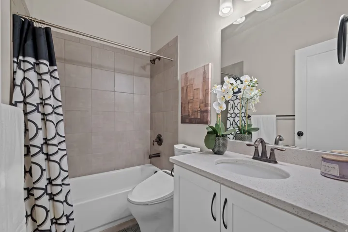 Bathroom with shower / bath combo and vanity
