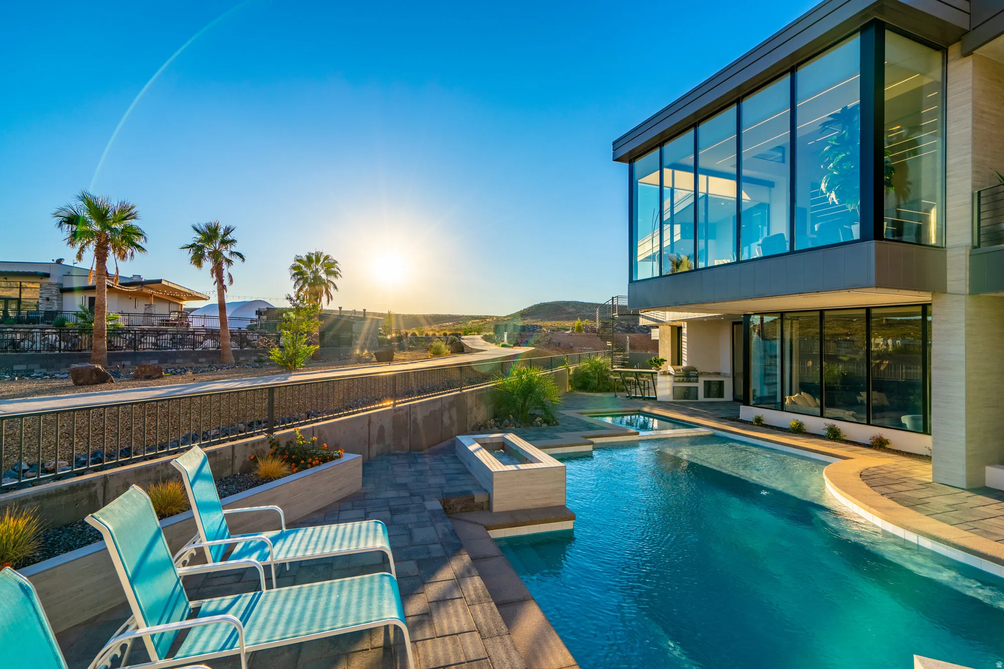 View of pool with a patio, a pool with connected hot tub, and a balcony