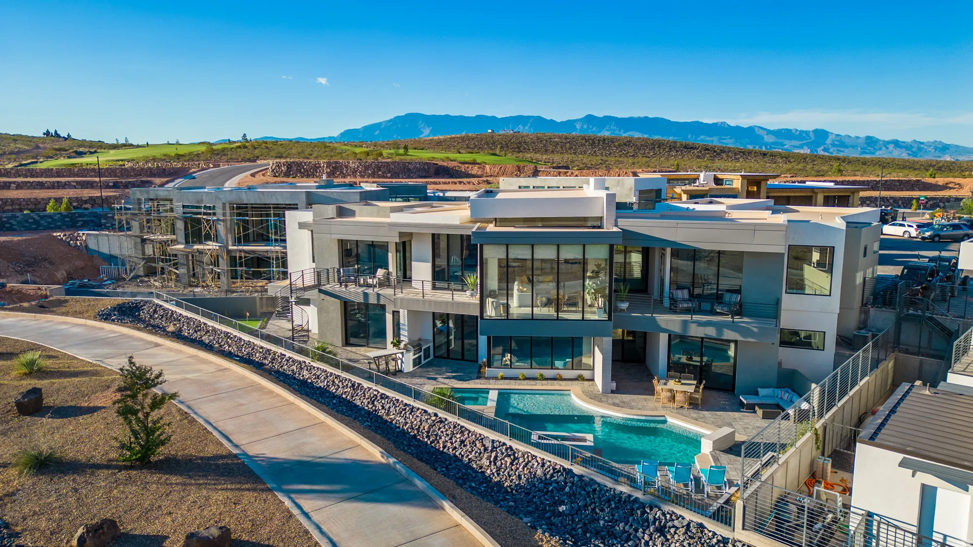 Back of house with a fenced backyard, a patio, a balcony, and an outdoor pool