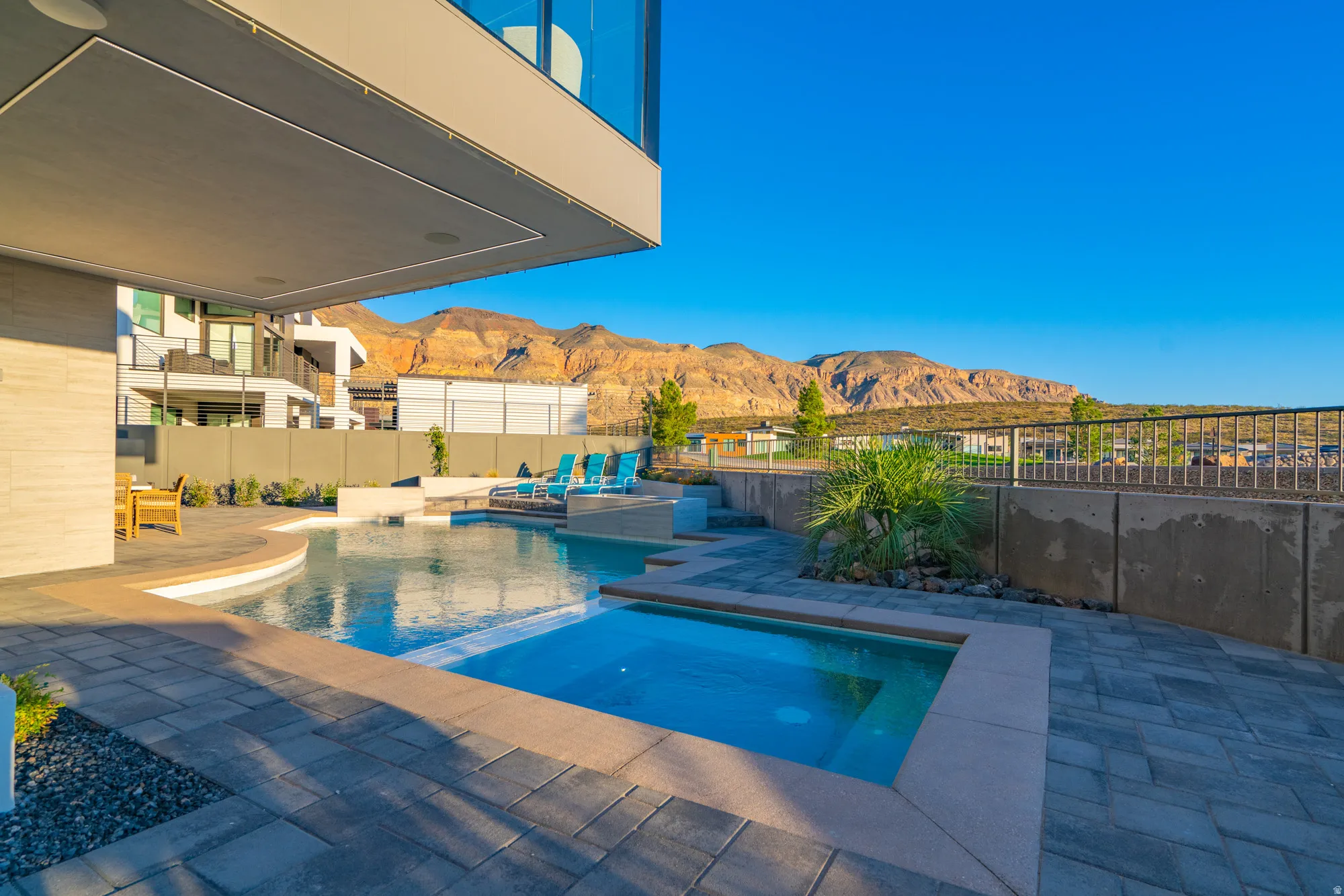 View of pool featuring a mountain view, an in-ground hot tub, a patio area, and a fenced backyard