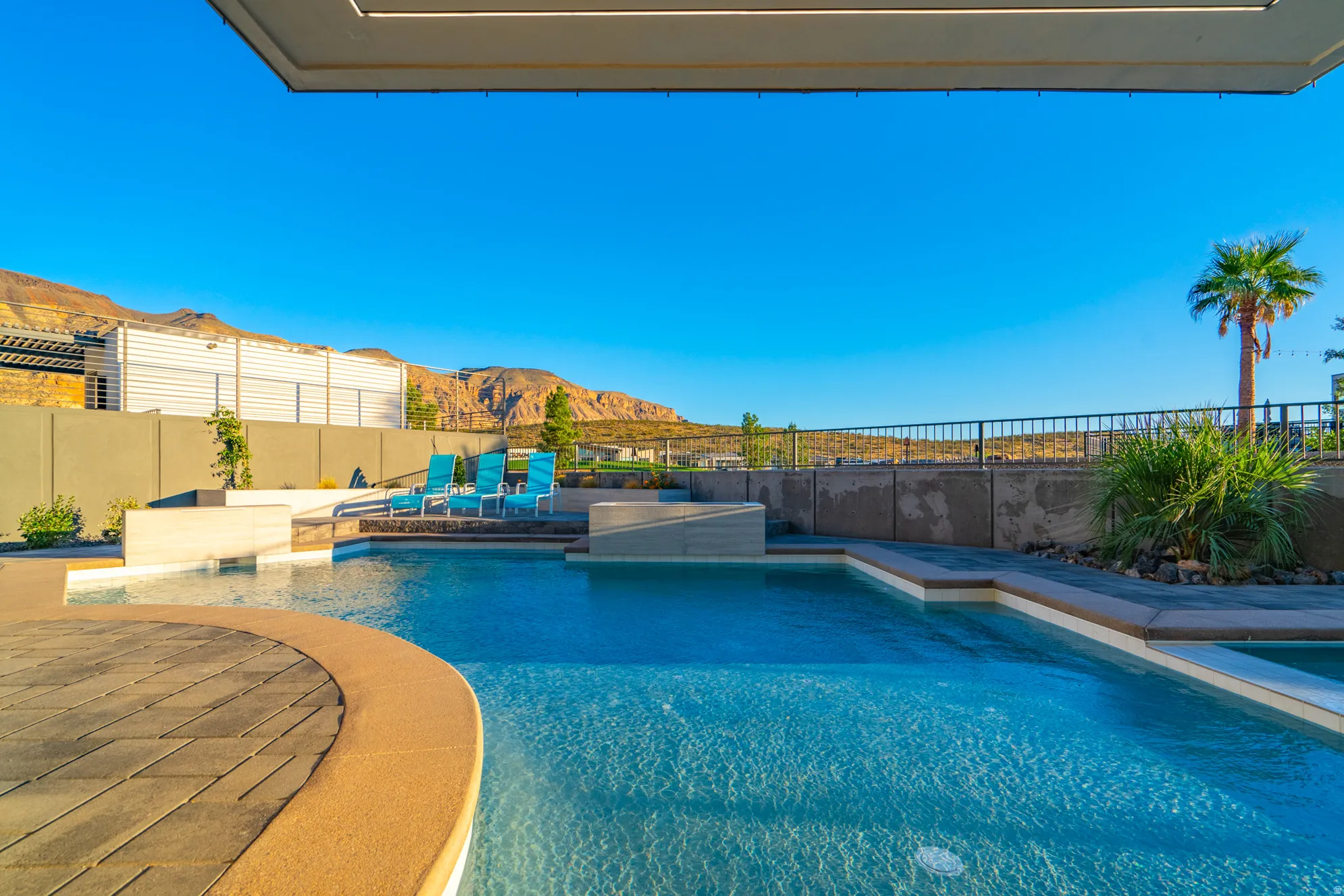 View of pool with a mountain view, a fenced backyard, and a patio area